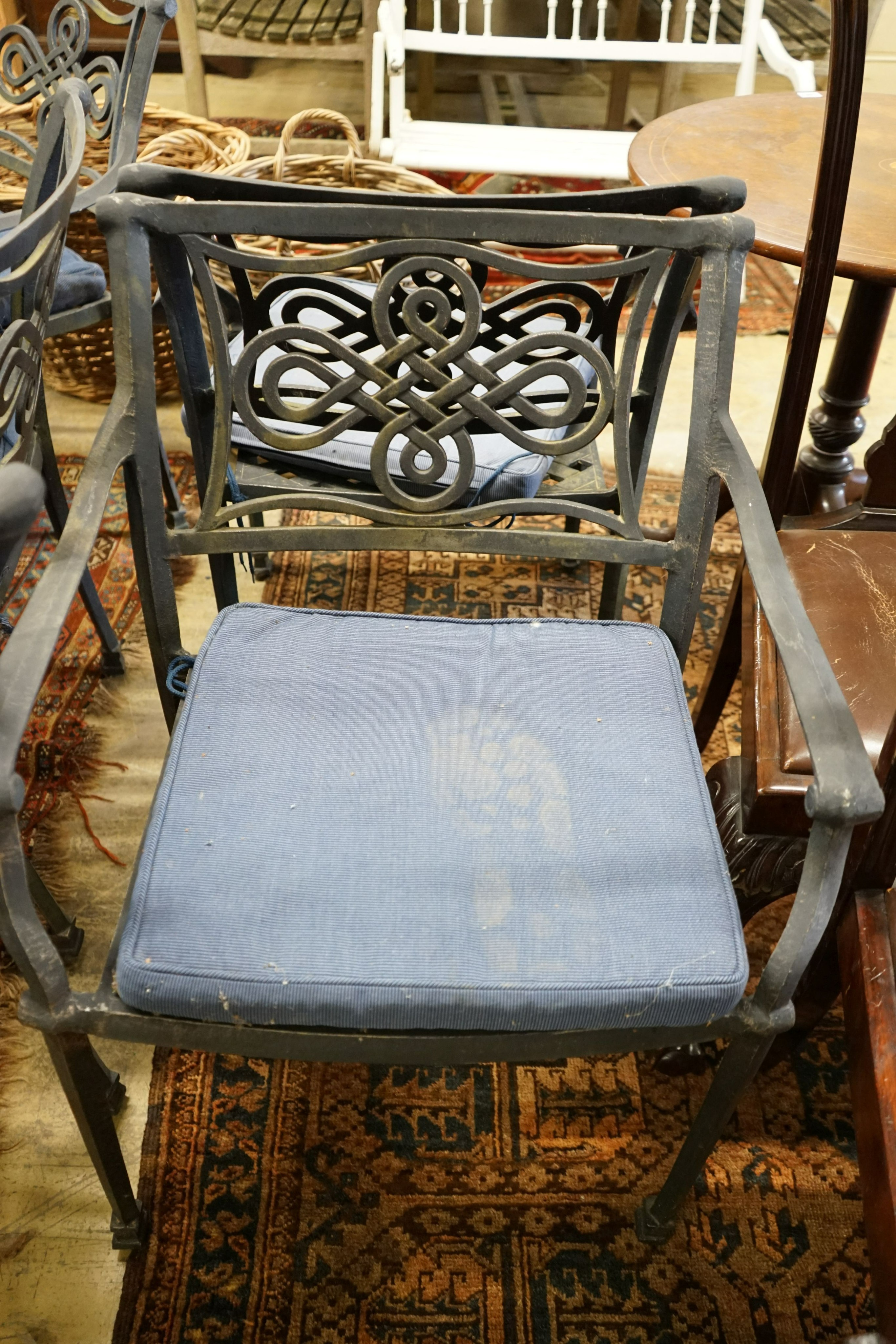 A circular painted aluminium garden table with 'lazy Susan', diameter 180cm, height 73cm together with ten aluminium elbow chairs with seat pads, (one base strut missing from table).